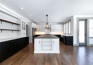 Modern farmhouse two-tone kitchen in painted white inset shaker door and espresso stained slab with large white island