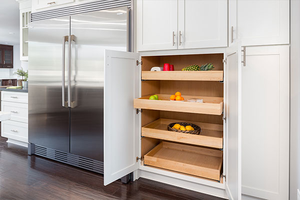 White shaker refrigerator surround with tall pantry cabinets and utility cabinets