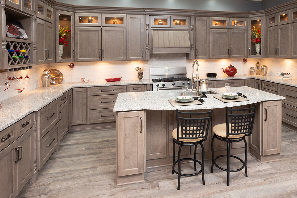 Light brown stained kitchen cabinets with an island and white countertops Light brown stained kitchen cabinets with an island and white countertops