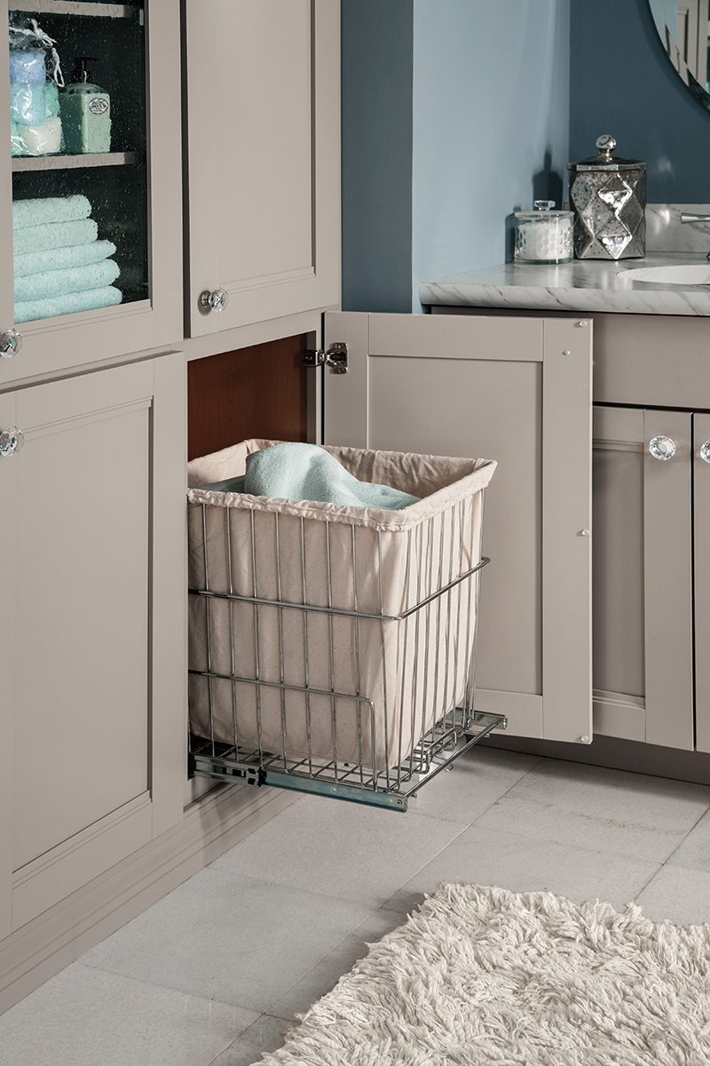 Gray Pull-Out Cabinet Organizers in Bathroom Designs. This image is of gray pull-our cabinet organizers in a bathroom design used to store laundry.