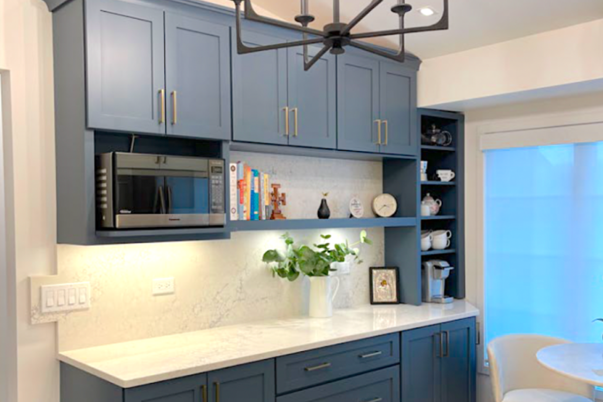 Medium blue buffet kitchen cabinets with light cream stone countertops Medium blue buffet kitchen cabinets with light cream stone countertops