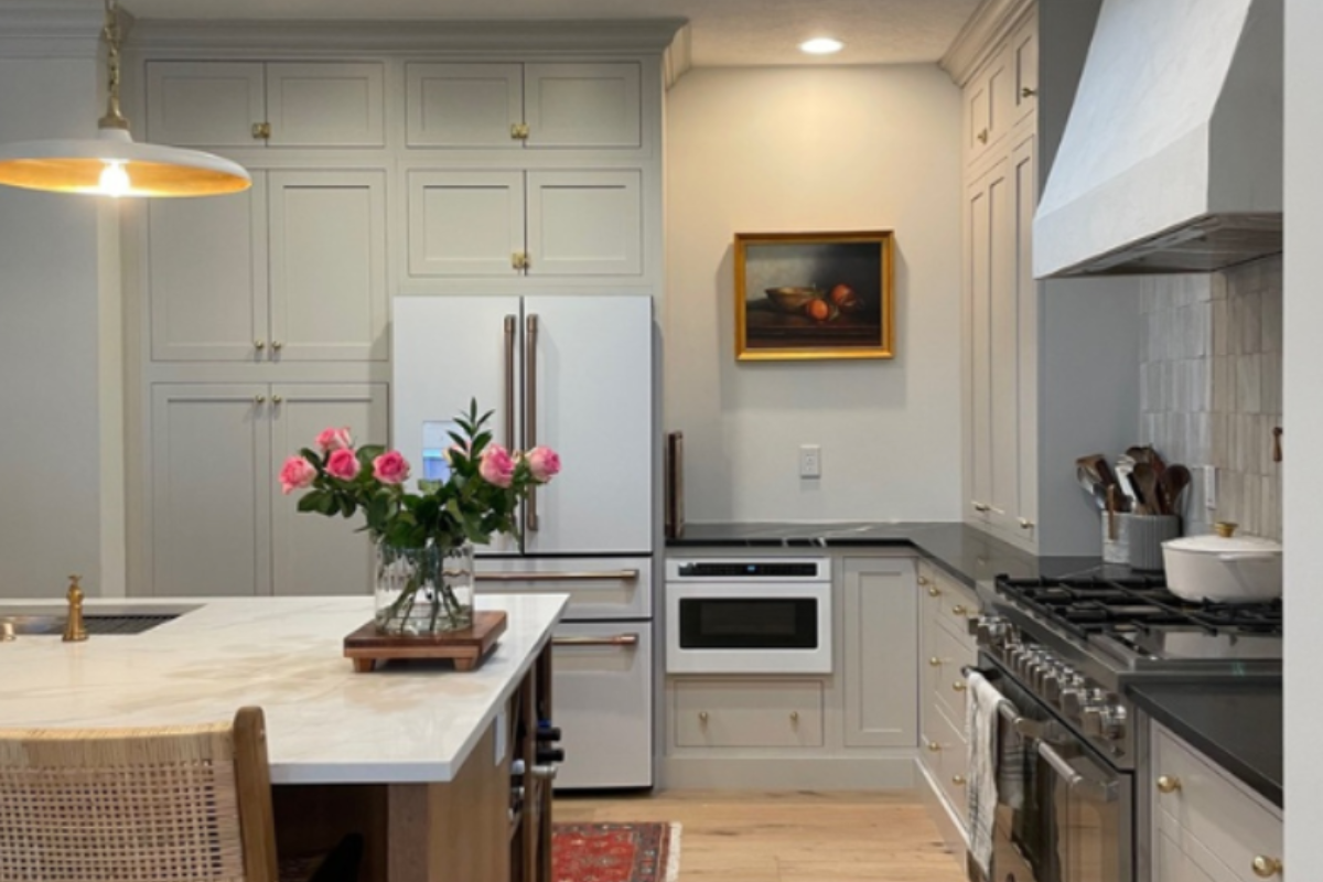 Light cream inset kitchen cabinets with medium wood toned kitchen island Light cream inset kitchen cabinets with medium wood toned kitchen island