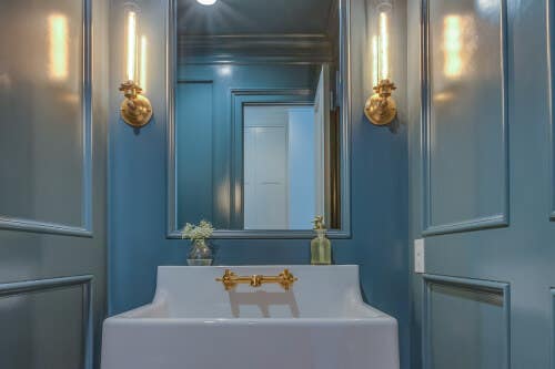Bright blue paneled powder room Bright blue paneled powder room with porcelain sink