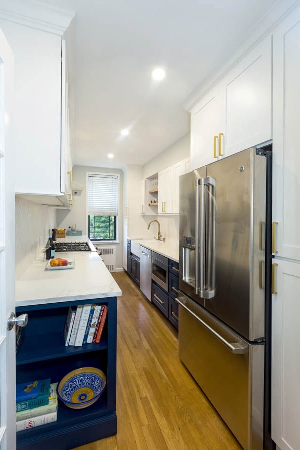galley kitchen with bllue and white cabinets, stainless appliances and gold hardware galley kitchen with blue and white cabinets, stainless appliances and gold hardware