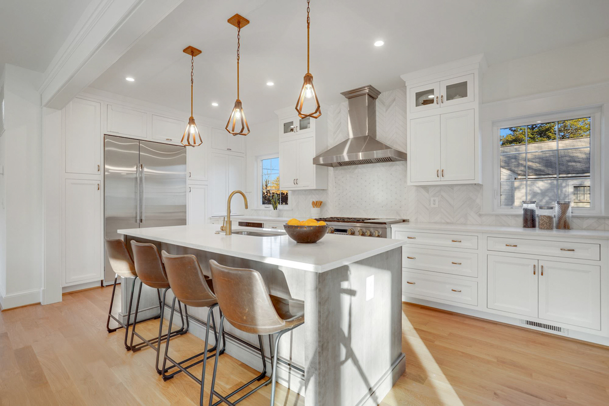 Stacked white shaker inset kitchen cabinets with a light gray stained island and white quartz countertops Stacked white shaker inset kitchen cabinets with a light gray stained island and white quartz countertops