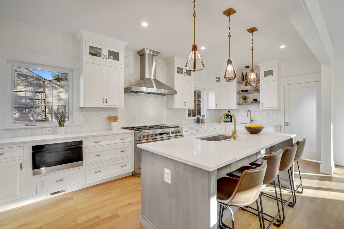 Stacked white shaker inset kitchen cabinets with a light gray stained island and white quartz countertops Stacked white shaker inset kitchen cabinets with a light gray stained island and white quartz countertops