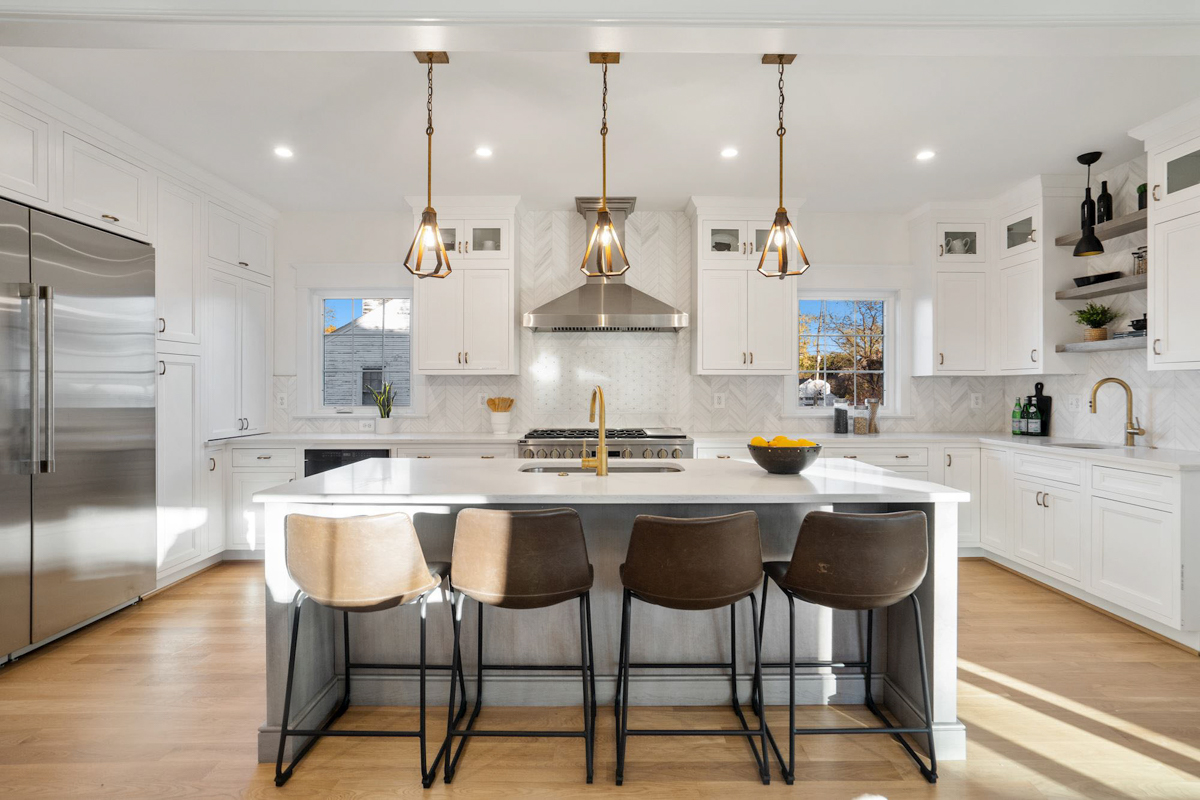 Stacked white shaker inset kitchen cabinets with a light gray stained island and white quartz countertops Stacked white shaker inset kitchen cabinets with a light gray stained island and white quartz countertops