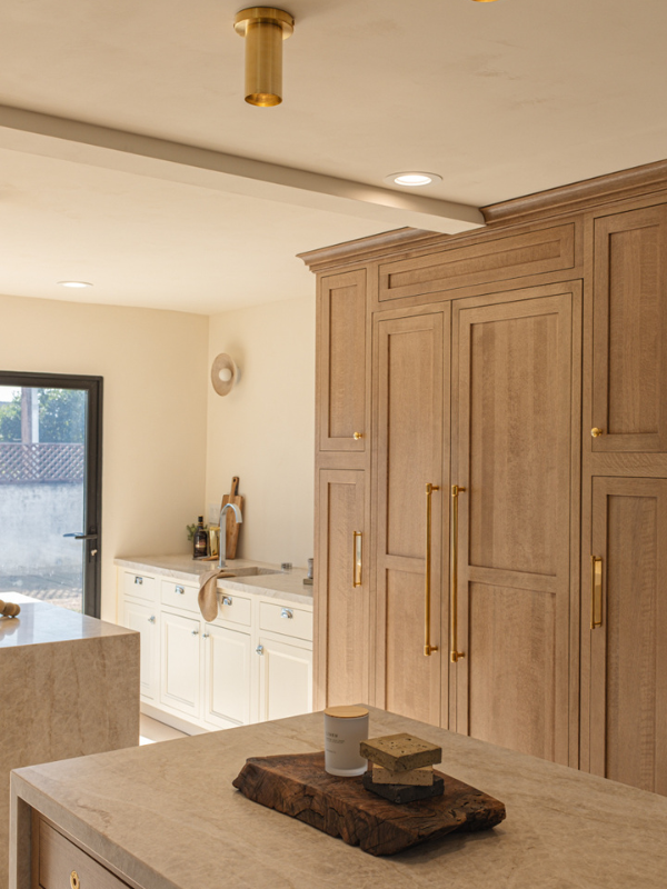 Two wood inset kitchen islands in front of a paneled refrigerator wall in the same light wood finish Two wood inset kitchen islands in front of a paneled refrigerator wall in the same light wood finish