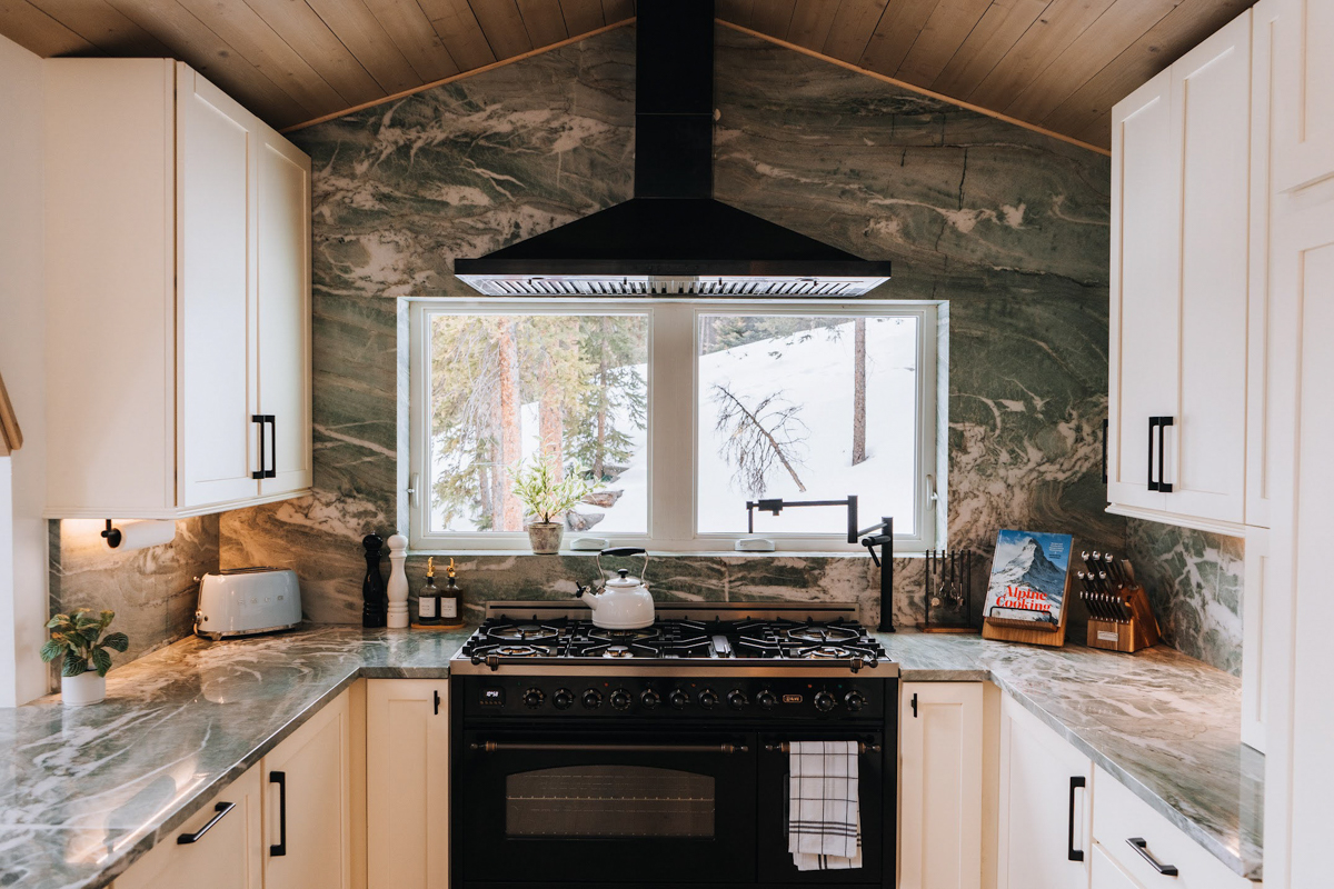 U-shaped white shaker kitchen design with modern black handles and green natural stone countertops and slab backsplash U-shaped white shaker kitchen design with modern black handles and green natural stone countertops and slab backsplash