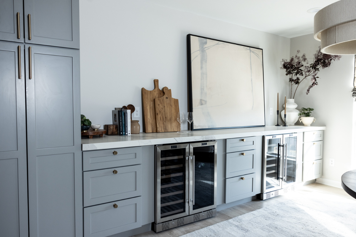Built-in dining room sideboard in light gray shaker base cabinets with gold cabinet hardware and white quartz countertops Built-in dining room sideboard in light gray shaker base cabinets with gold cabinet hardware and white quartz countertops