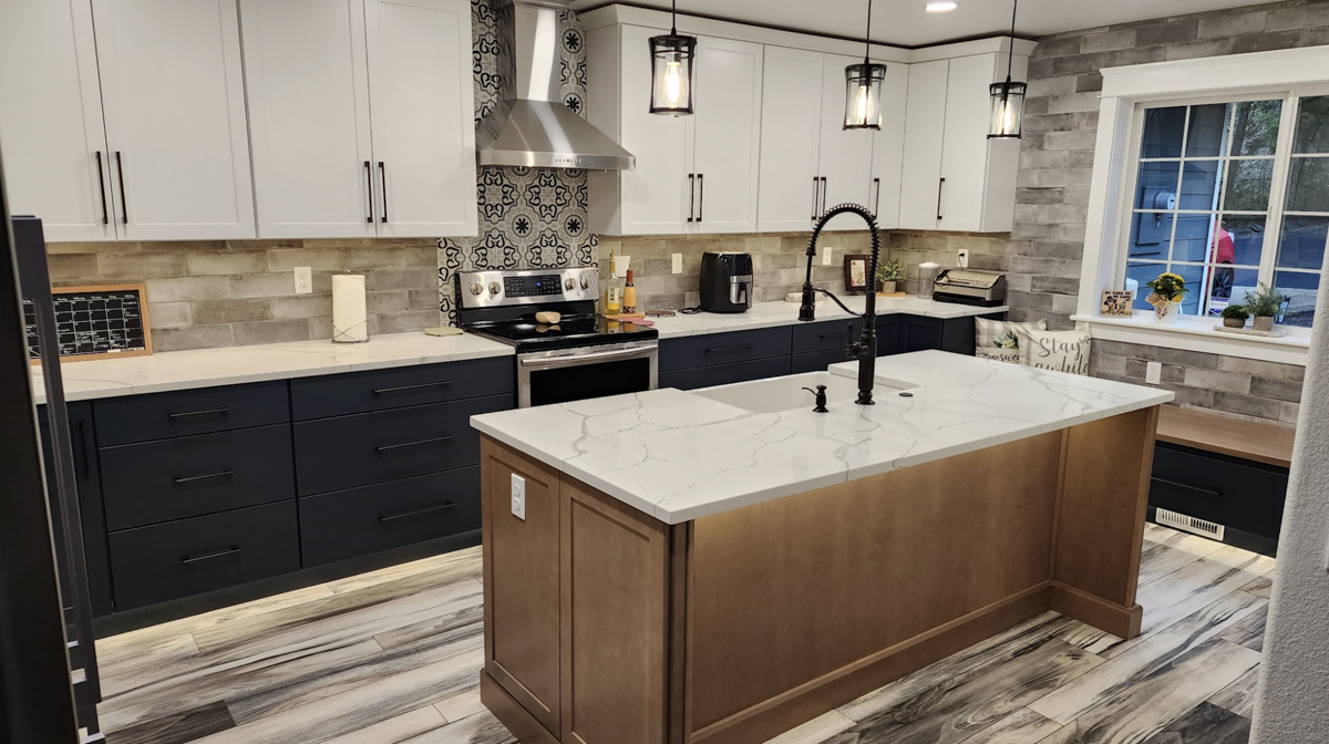 Farmhouse kitchen with white shaker wall cabinets, blue shaker base cabinets, and light wood furniture-style island Farmhouse kitchen with white shaker wall cabinets, blue shaker base cabinets, and light wood furniture-style island