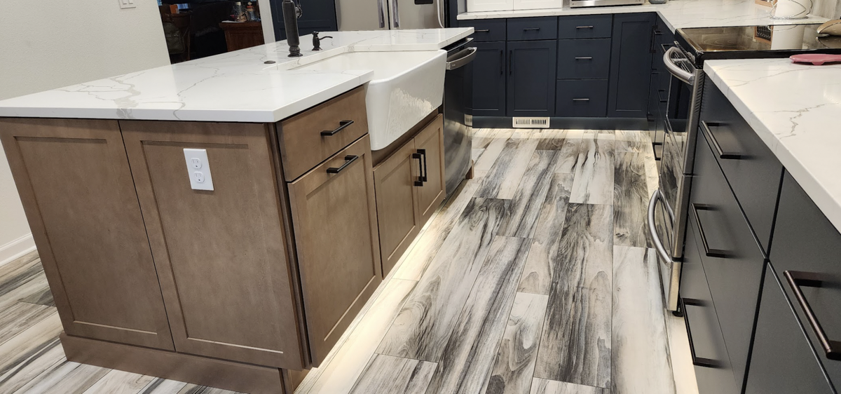 Farmhouse kitchen with white shaker wall cabinets, blue shaker base cabinets, and light wood furniture-style island Farmhouse kitchen with white shaker wall cabinets, blue shaker base cabinets, and light wood furniture-style island