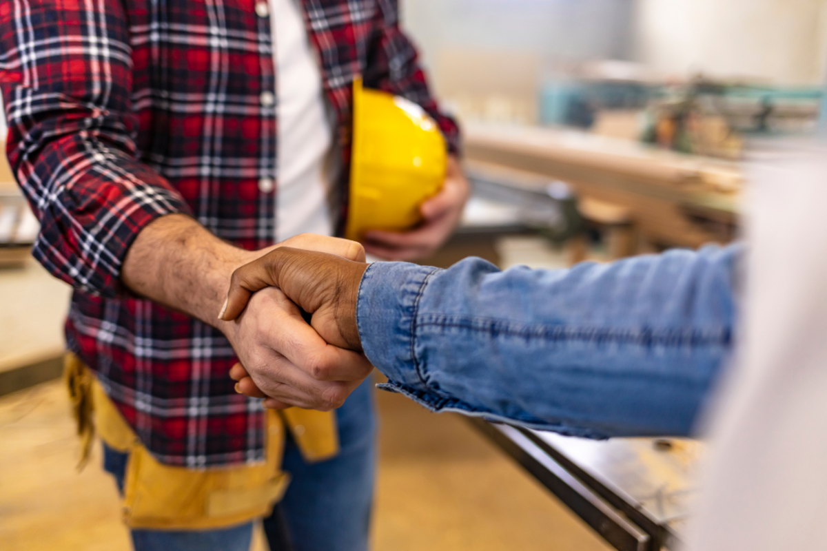 Contractor and homeowner shaking hands Contractor and homeowner shaking hands