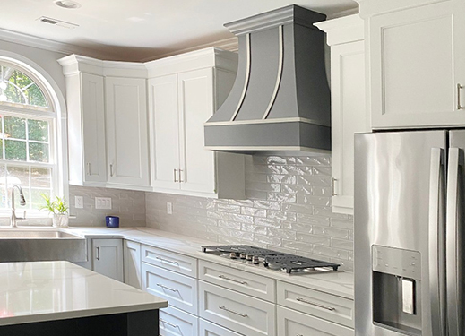 Curved wood kitchen hood in gray finish with steel strapping Curved wood kitchen hood in gray finish with steel strapping
