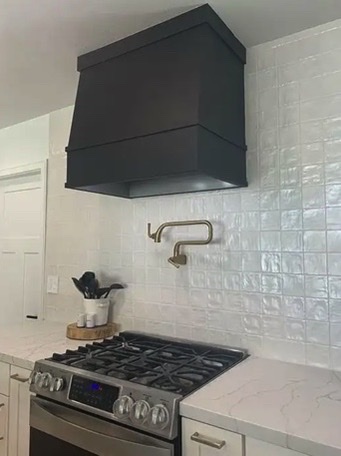 Black Colored Wood Range Hood installed in modern kitchen Black Colored Wood Range Hood installed in modern kitchen