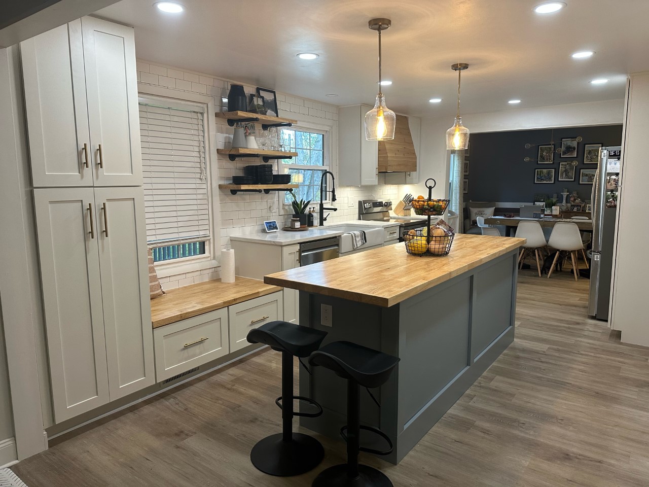 CliqStudios project: White shaker kitchen with pine wood hood and light gray island cabinets CliqStudios project: White shaker kitchen with pine wood hood and light gray island cabinets