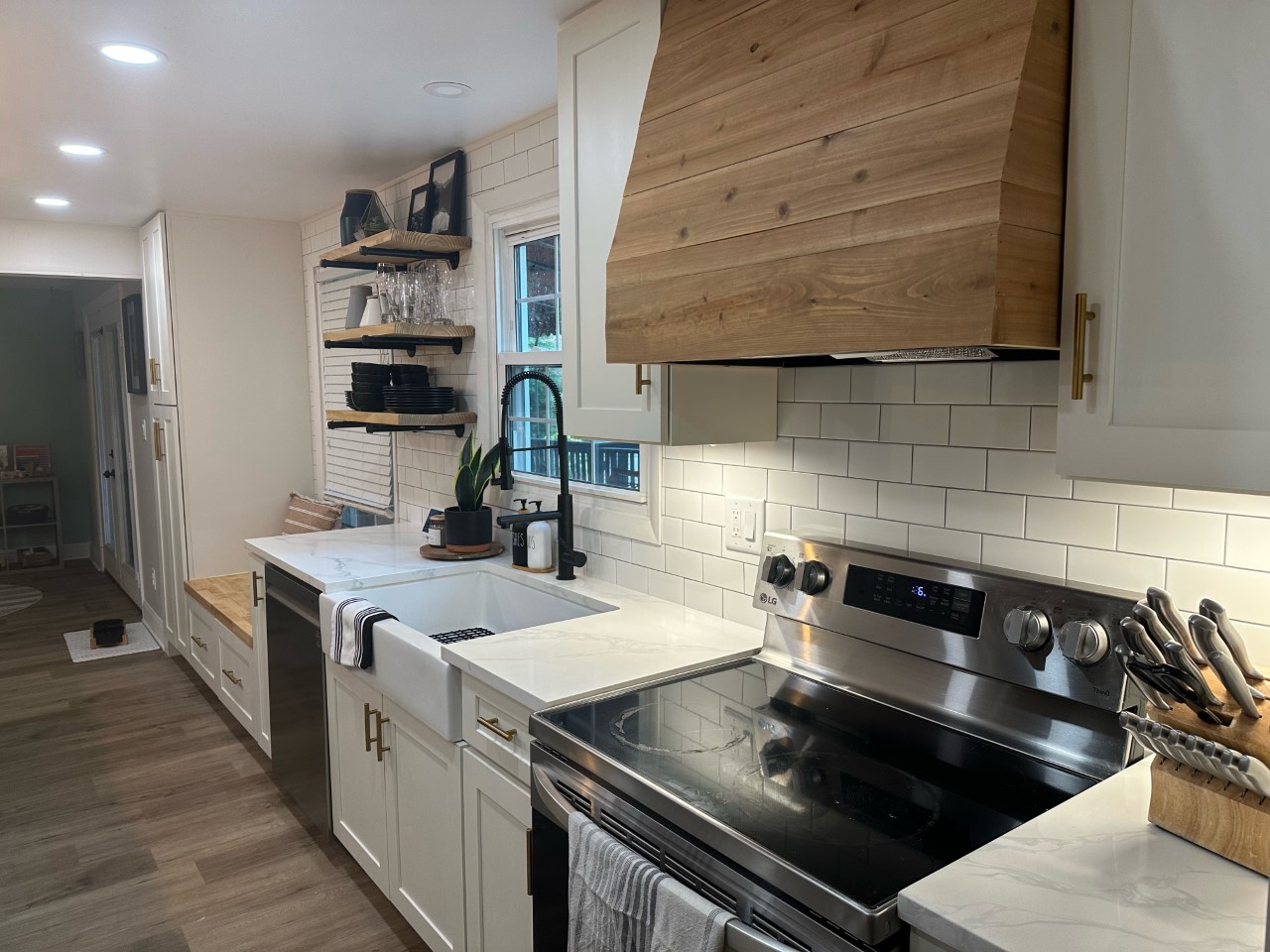 CliqStudios project: White shaker kitchen with pine wood hood and light gray island cabinets CliqStudios project: White shaker kitchen with pine wood hood and light gray island cabinets