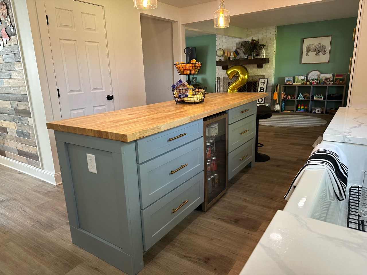 CliqStudios project: Light gray shaker kitchen island drawer cabinets with a beverage cooler in the center and wood butcher block countertop CliqStudios project: Light gray shaker kitchen island drawer cabinets with a beverage cooler in the center and wood butcher block countertop