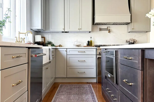 Duluth Pebble kitchen cabinets Transitional two-tone shaker kitchen design with beige cabinets and a dark brown stained island