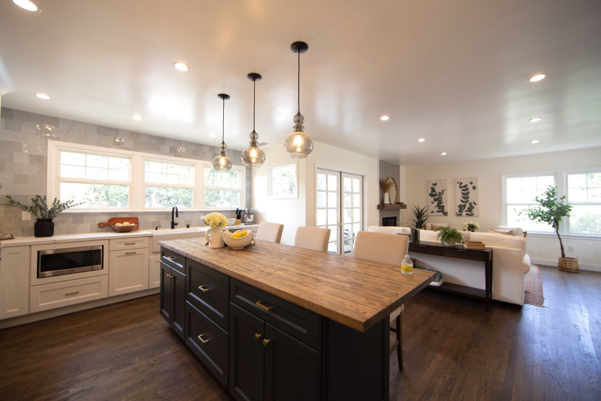 Decorative white shaker kitchen cabinets with white quartz countertops, gold hardware, and an indigo blue island with butcher block countertops Decorative white shaker kitchen cabinets with white quartz countertops, gold hardware, and an indigo blue island with butcher block countertops