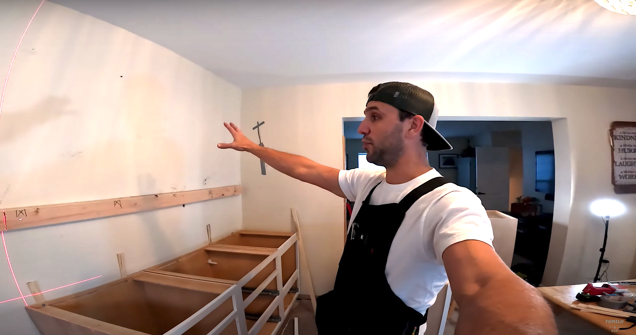 Mike Sante of Family DIY TV using a ledger rail to support wall cabinets during cabinet installation Mike Sante of Family DIY TV using a ledger rail to support wall cabinets during cabinet installation