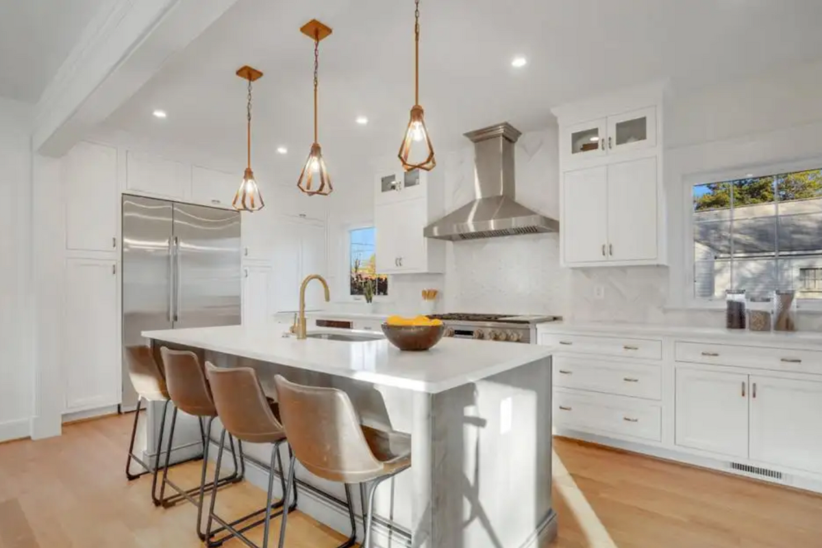 White inset kitchen cabinets with stacked glass cabinets above and a large gray stained kitchen island White inset kitchen cabinets with stacked glass cabinets above and a large gray stained kitchen island