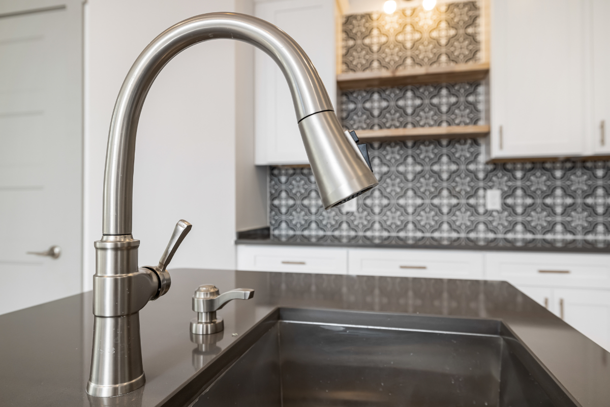 Brushed nickel goose-neck faucet with pull-down sprayer Brushed nickel goose-neck faucet with pull-down sprayer