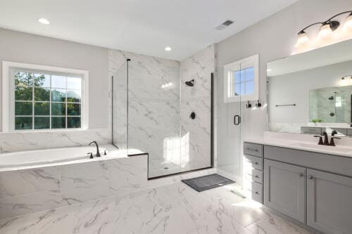 Gray shaker-style vanity with white countertop Gray shaker-style vanity with white countertop surrounded by marble