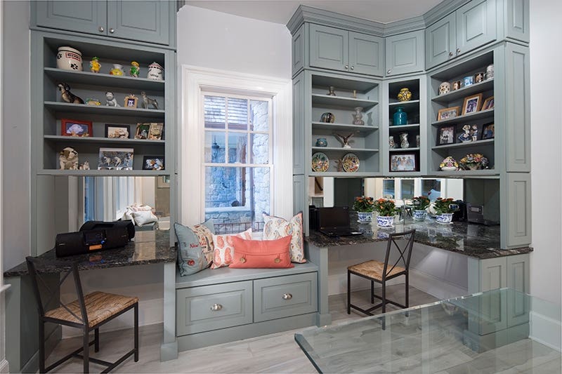 Decorative light gray office cabinetry with decorated open shelves and bench seat Decorative light gray office cabinetry with decorated open shelves and bench seat