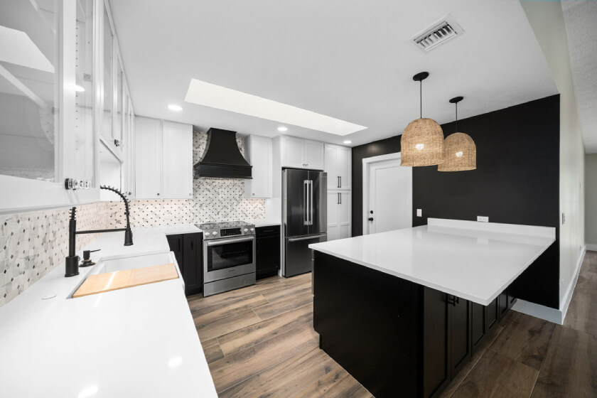 Harrison Carriage Black and Sea Salt kitchen cabinets White and black shaker kitchen design with black wood hood and island with white quartz countertops