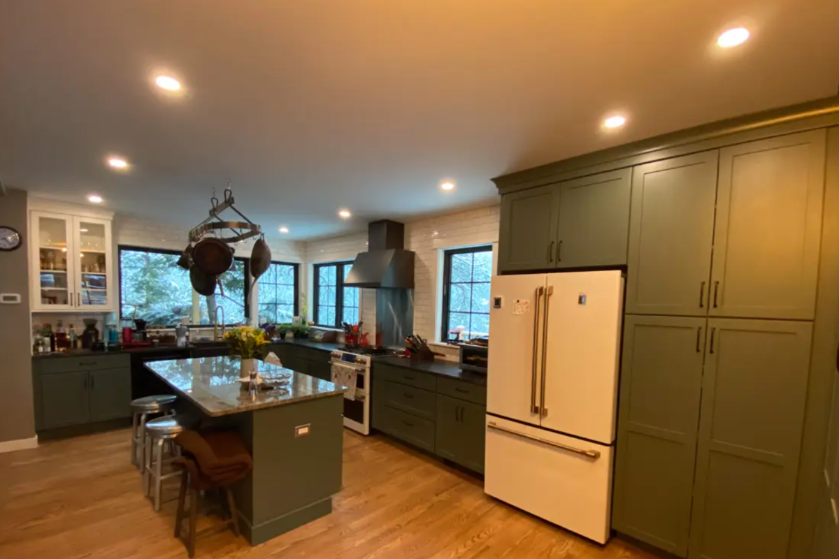 L-shaped dark green kitchen cabinet design with white and gold appliances and granite countertops L-shaped dark green kitchen cabinet design with white and gold appliances and granite countertops