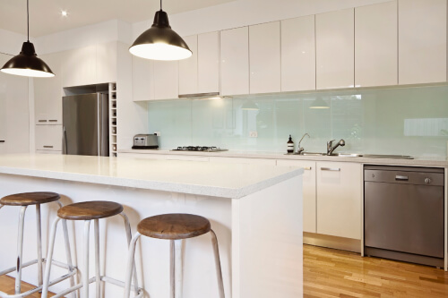 All white kitchen with high-gloss cabinets, light blue glass backsplash, white quartz countertops and black farmhouse pendant lighting All white kitchen with high-gloss cabinets, light blue glass backsplash, white quartz countertops and black farmhouse pendant lighting