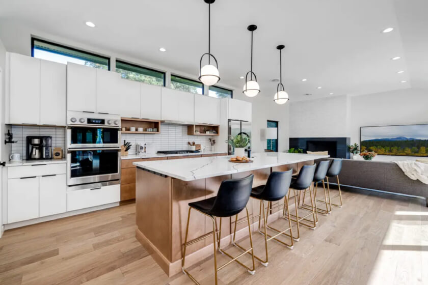 Jensen Lily and Harvest kitchen cabinets Mid-Century Modern kitchen design with slab door cabinets in white and a warm wood-toned island