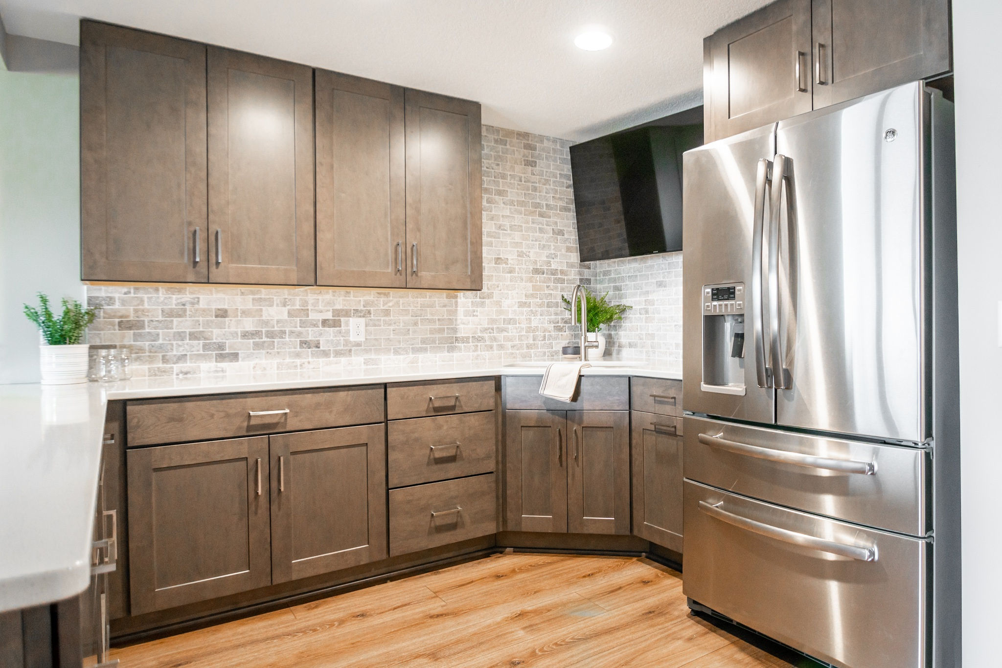 CliqStudios project: Warm wood shaker kitchen cabinets in a basement bar with tile backsplash CliqStudios project: Warm wood shaker kitchen cabinets in a basement bar with tile backsplash