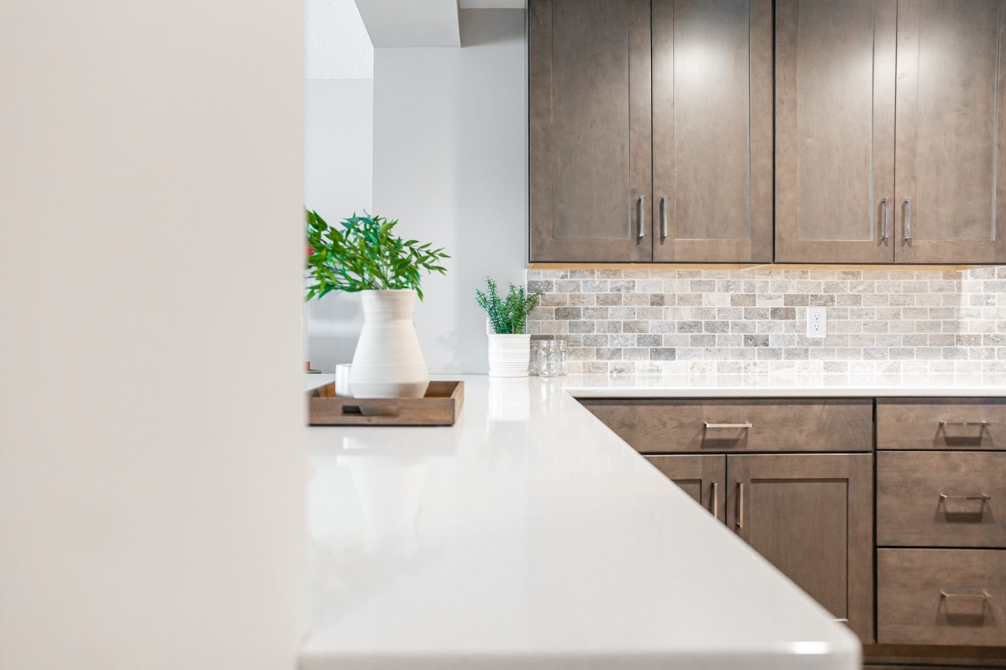 CliqStudios project: Warm wood shaker kitchen cabinets in a basement bar with tile backsplash CliqStudios project: Warm wood shaker kitchen cabinets in a basement bar with tile backsplash