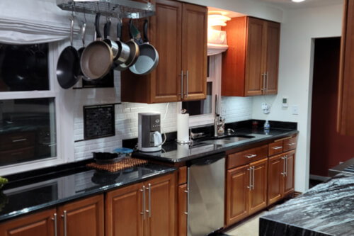 Medium wood tone raised panel kitchen cabinets Medium wood tone red kitchen cabinets in raised panel style
