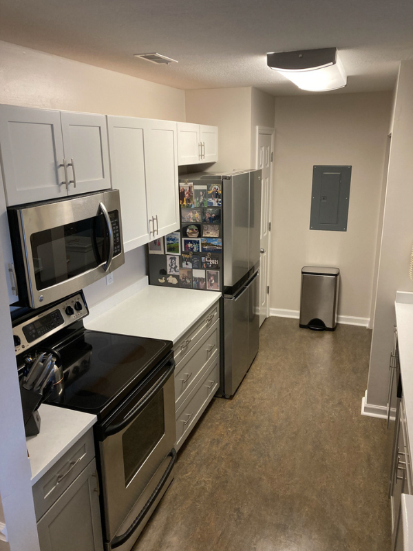 Shaker galley kitchen with white wall cabinets, gray base cabinets, and white quartz countertops Shaker galley kitchen with white wall cabinets, gray base cabinets, and white quartz countertops