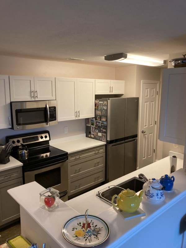 Shaker galley kitchen with white wall cabinets, gray base cabinets, and white quartz countertops Shaker galley kitchen with white wall cabinets, gray base cabinets, and white quartz countertops