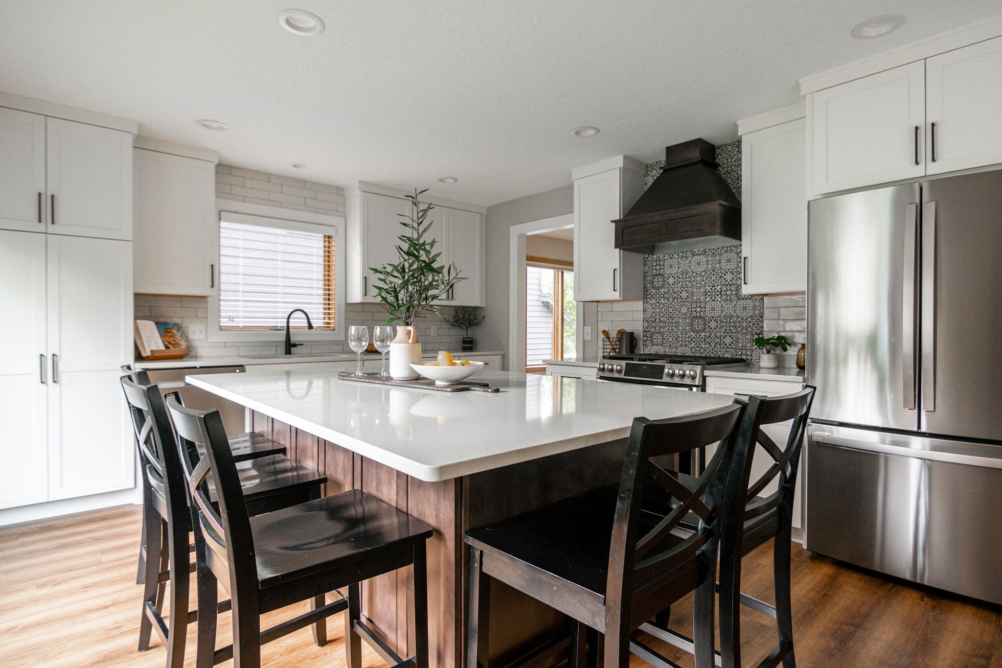 CliqStudios project: White shaker kitchen cabinetry with dark wood stained island and wood kitchen hood CliqStudios project: White shaker kitchen cabinetry with dark wood stained island and wood kitchen hood