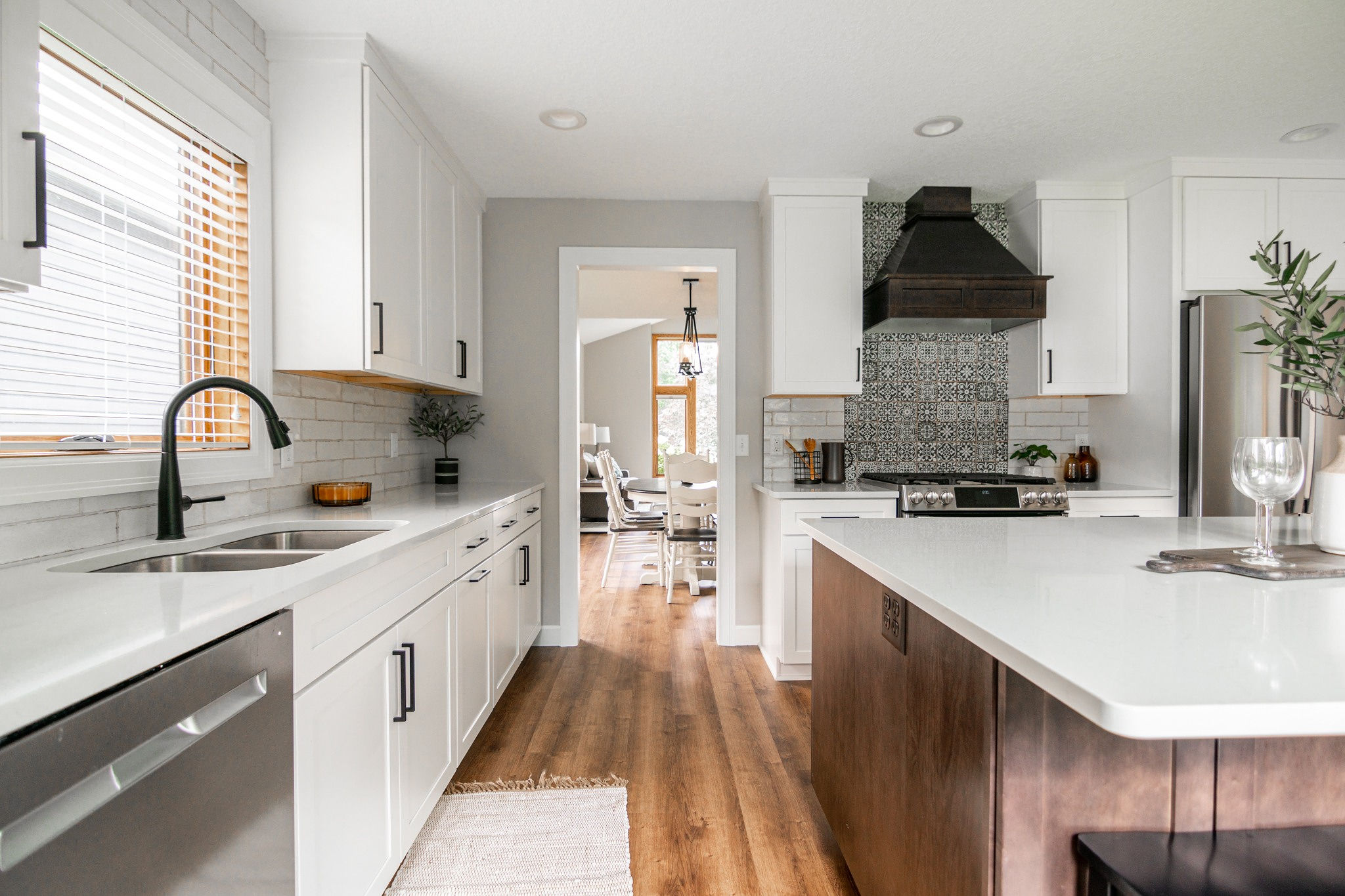 CliqStudios project: White shaker kitchen cabinetry with dark wood stained island and wood kitchen hood CliqStudios project: White shaker kitchen cabinetry with dark wood stained island and wood kitchen hood