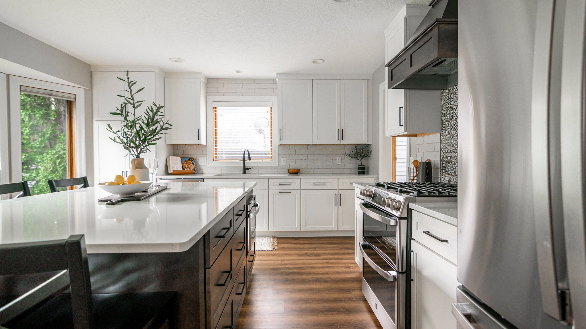 CliqStudios project: White shaker kitchen cabinetry with dark wood stained island and wood kitchen hood CliqStudios project: White shaker kitchen cabinetry with dark wood stained island and wood kitchen hood