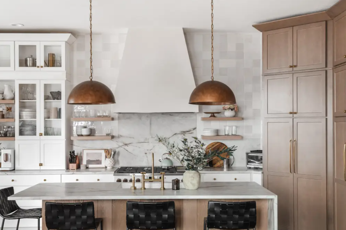Two-tone white and light wood kitchen design Two-tone white and light wood kitchen design with a plaster hood and copper accents