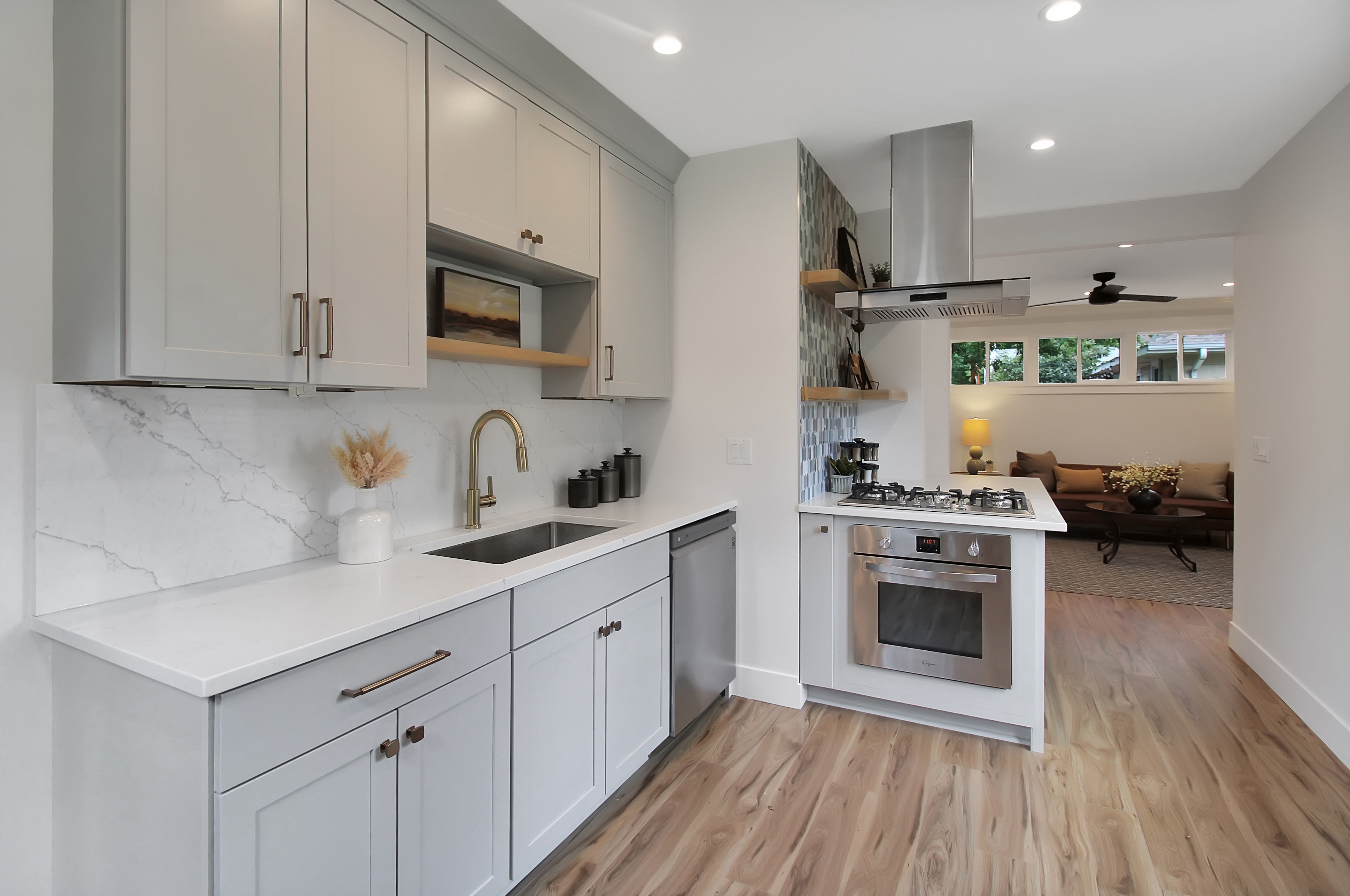 CliqStudios project: Light gray, one-wall shaker kitchen cabinets with brass hardware, and marble slab backsplash CliqStudios project: Light gray, one-wall shaker kitchen cabinets with brass hardware, and marble slab backsplash