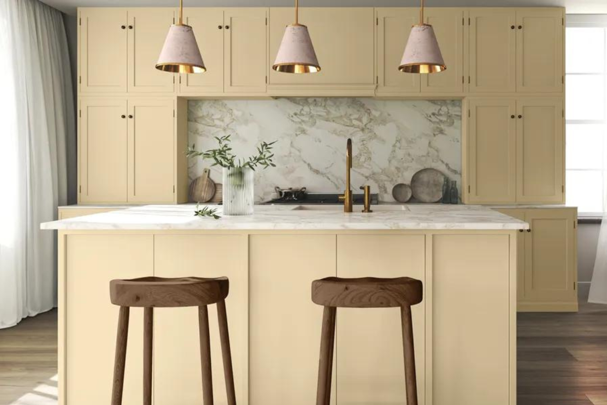 Light creamy yellow kitchen design with marble backsplash and countertop Light creamy yellow kitchen design with marble backsplash and countertop