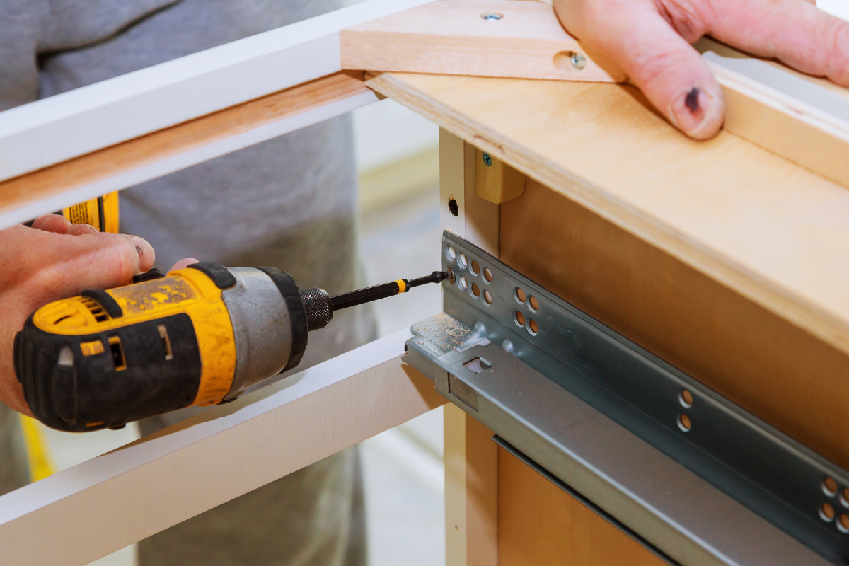Cabinet installation professional installing drawer glides Cabinet installation professional installing drawer glides