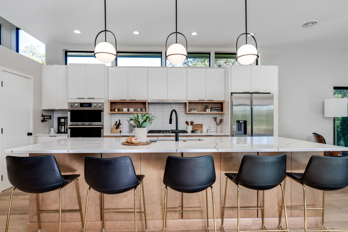 Mid-century modern kitchen design with white slab cabinets along one wall with warm wood base cabinets and accents plus a warm wood kitchen island and white quartz countertops Mid-century modern kitchen design with white slab cabinets along one wall with warm wood base cabinets and accents plus a warm wood kitchen island and white quartz countertops