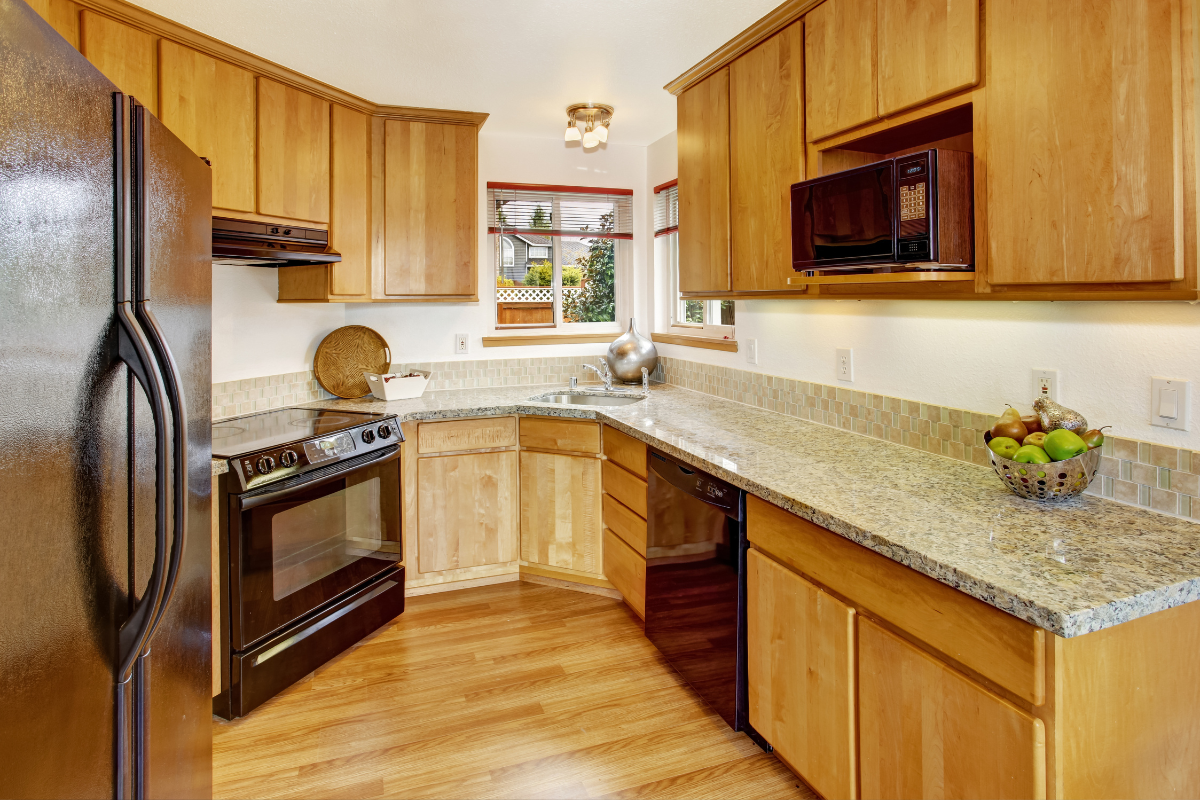 Small modern oak slab kitchen design in unique U-shape layout Small modern oak slab kitchen design