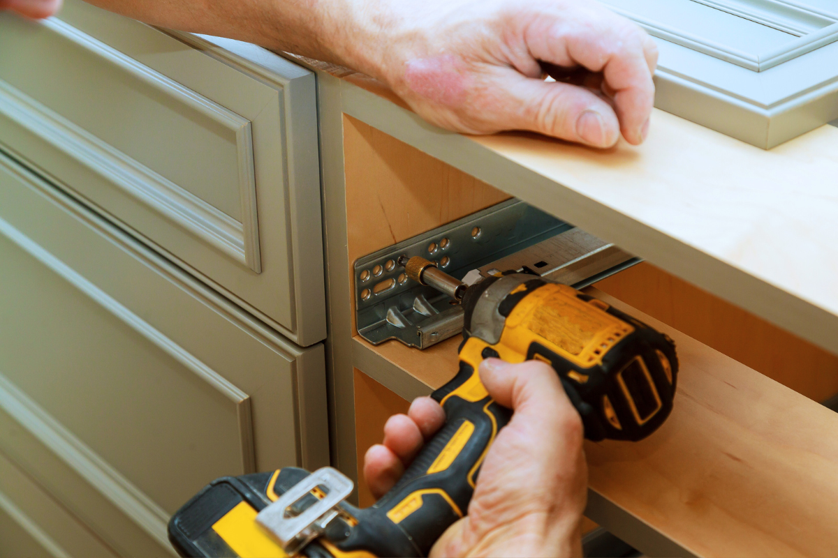 Soft-close drawer glide installation inside a green drawer base cabinet Soft-close drawer glide installation inside a green drawer base cabinet