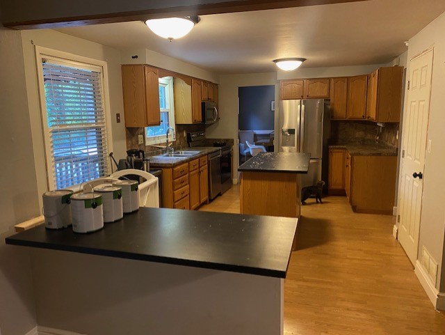 Golden oak kitchen cabinets and black laminate countertops Golden oak kitchen cabinets and black laminate countertops