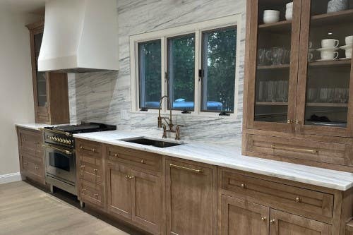 Brentwood Oak Cappuccino kitchen cabinets Transitional furniture-style kitchen design in light wood kitchen cabinets with gold hardware and white and blue countertops and matching slab backsplash